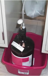 Four liter brown glass HPLC waste container with modified cap and exhaust filter.